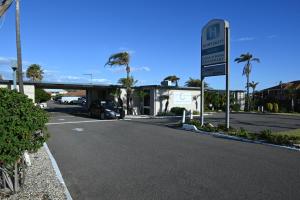 a car parked at a gas station with a sign at Hospitality Geraldton SureStay Collection by Best Western in Geraldton