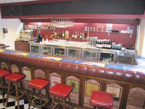 a bar with red stools in a restaurant at Bay & Basin in Sanctuary Point