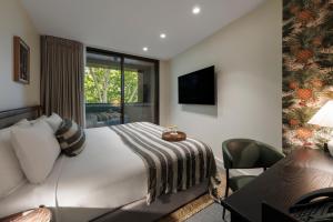 a hotel room with a large bed and a desk at 202 Elizabeth in Sydney