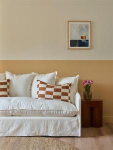 un sofá blanco con almohadas en la sala de estar en The Isla, en Batemans Bay