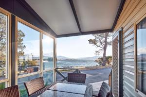 a house with a view of the water at NRMA Jindabyne Holiday Park in Jindabyne