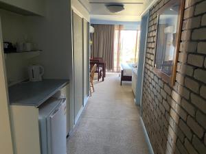 a hallway with a kitchen and a living room at Abel Tasman Waterfront Motel in Lakes Entrance