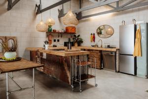 a kitchen with a wooden counter and a refrigerator at Sea Siren in Paternoster