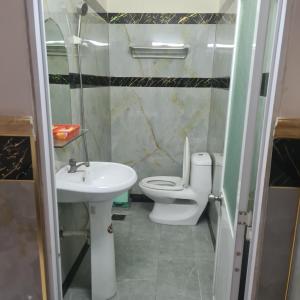 a bathroom with a toilet and a sink at HONG CUC Hotel in Ho Chi Minh City