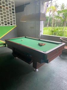 a pool table in a room with afits at PACA'S Reggae Bar & Hostel in Ambat