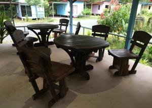 a group of tables and chairs sitting on a porch at Baan Pak Wangthong in Ban Dung