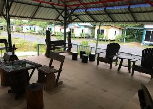 a group of chairs and tables on a patio at Baan Pak Wangthong in Ban Dung