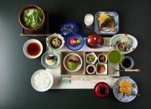 a table filled with dishes of food on a table at Wakamatsu Hot Spring Resort in Hakodate