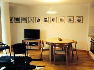a living room with a table and a television at Apartment in Druskininkai Lithuania in Druskininkai
