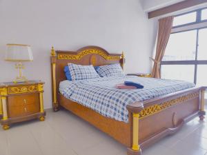 a bedroom with a bed with a wooden frame and a window at Fahrenheit 88 Pavillion By Abby comfy stay in Kuala Lumpur
