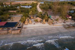 an aerial view of a beach with a group of resorts at Young Wild and Free in Koh Kong