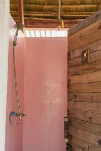 a shower in a bathroom with a pink wall at Young Wild and Free in Koh Kong +48 photos