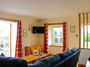 a living room with a couch and a table at Laurel Bank in Alyth