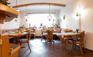 a restaurant with tables and chairs in a room at Landhotel Biberburg in Bad Liebenwerda