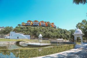 a group of houses on top of a hill at Bamboo Saa Resort & Spa - Udaipur in Udaipur