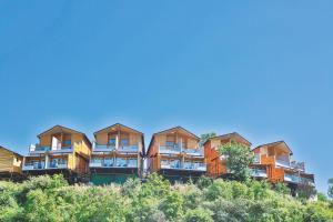 a row of apartment buildings on top of a hill at Bamboo Saa Resort & Spa - Udaipur in Udaipur