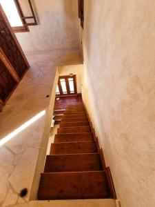 a stairway in a building with a stair case at A Home with a Dome in ‘Izbat Ţanāţī