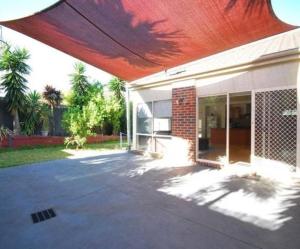 a house with a red roof and a patio at House on the Heights in Lyndhurst