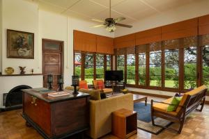 a living room with a couch and a tv at Jetwing Uva Ben Head Villa in Welimada