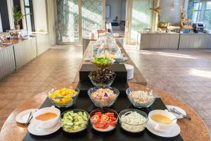 a tray with bowls of food on a table at Mike Garden Resort - SHA EXTAR PLUS in Pattaya Central