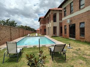 a swimming pool in the yard of a house at Magnolia Hotel in Middelburg