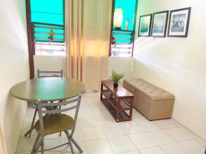 a living room with a table and a couch and a table and chair at Ban Lake View in Pak Chong