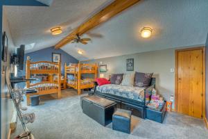 a living room with a bed and two bunk beds at FC17 Stylishly renovated Forest Cottage walk to Bretton Woods ski trails wifi cable ping pong in Carroll
