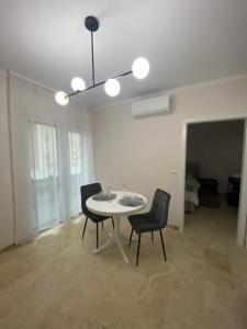 a dining room with a table and two chairs at Apartament Timisoara 5 in Timişoara