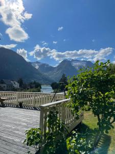 a view of the mountains from the deck of a house at Vollsnes Gjestehus in Stryn