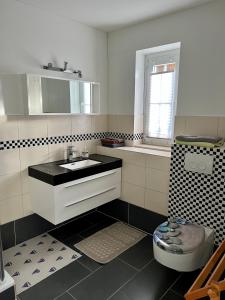 Baño blanco con lavabo y aseo en Ferienwohnung Nordlicht en Rostock