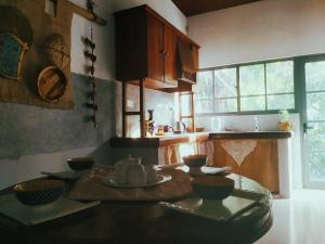 a kitchen with a table with dishes on it at Barefoot Inn Kandy in Kandy