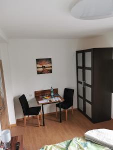 a dining room with a table and two chairs at HomeW4 - Tiny Apartment in Hoheneich