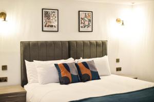 a bedroom with a large bed with two pillows at Terrace House in Leamington Spa