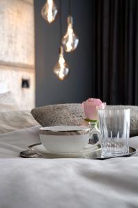 a table with a plate and a bowl and a glass at THE NEWSHA SIGNATURE HOME in Mülheim an der Ruhr