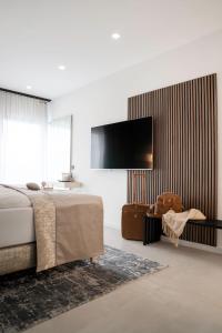 a bedroom with a bed and a flat screen tv at THE NEWSHA SIGNATURE HOME in Mülheim an der Ruhr
