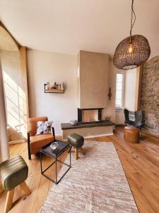 a living room with a couch and a fireplace at Boutique Hotel Marielle in Bad Münstereifel