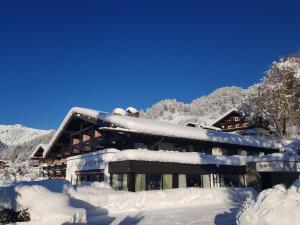 a building covered in snow with a lot of snow at Hotel Montjola Nova in Schruns-Tschagguns