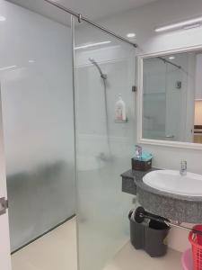 a bathroom with a glass shower and a sink at Căn hộ biển Phan Thiết Oceanvista- Sealink city in Phan Thiet