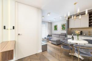 a kitchen and living room with a table and chairs at GA Luxury Apartments G244 in Krakow