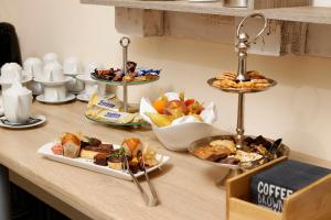 a buffet with plates of food on a counter at Hotel Plaza Hannover in Hannover