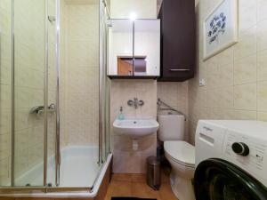 a bathroom with a shower toilet and a sink at Sliska 10 apartament in Warsaw