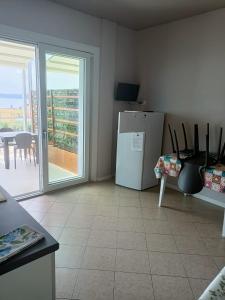 a kitchen with a refrigerator and a table with a balcony at Villa Molino in Moniga