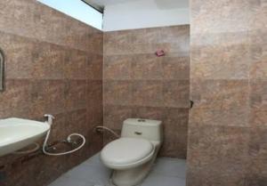 a bathroom with a toilet and a sink at Hotel Gwal Palace By WB Inn in Agra