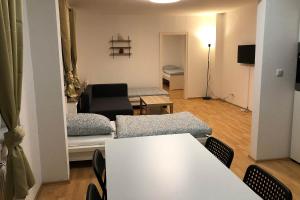 a living room with a table and a couch at cozy Apartments with WiFi in Oberhausen