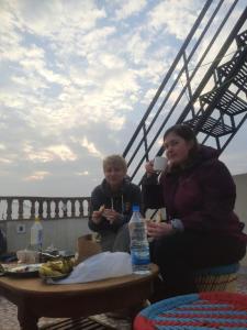 a man and a woman sitting around a table at S A HAVELI GUEST HOUSE in Bikaner