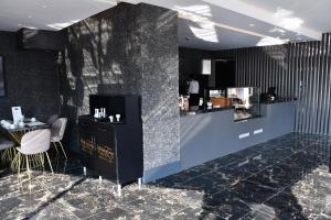 a restaurant with a counter and a table in a room at Hmz LUXURY HOTEL in Çekme