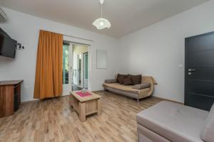 ein Wohnzimmer mit einer Couch und einem Tisch in der Unterkunft Guest House Malenica in Sukošan