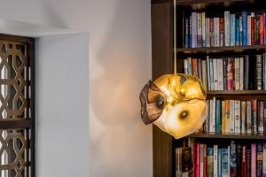 a mask hanging from a book shelf at Alto Hotel On Bourke in Melbourne