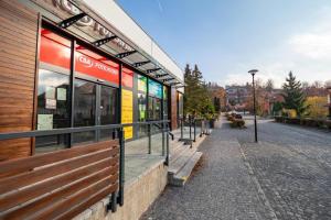 a bus stop with a bench next to a building at Apartmany Zechenterova in Kremnica