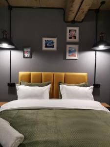 a bedroom with a large bed with a yellow headboard at Nomad Gudauri Twins 124 in Gudauri